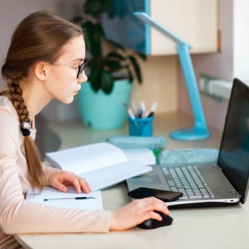 A teen struggles with her online classes while learning from home during the COVID-19 pandemic